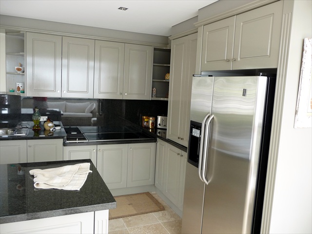 Brush finishing and repair of kitchen cabinets at Vaucluse